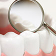 dental mirror resting on model teeth