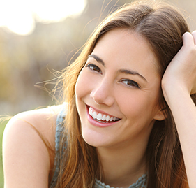 Woman smiling after all ceramic dental restoration