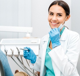 Dental hygienist smiling during teeth cleaning