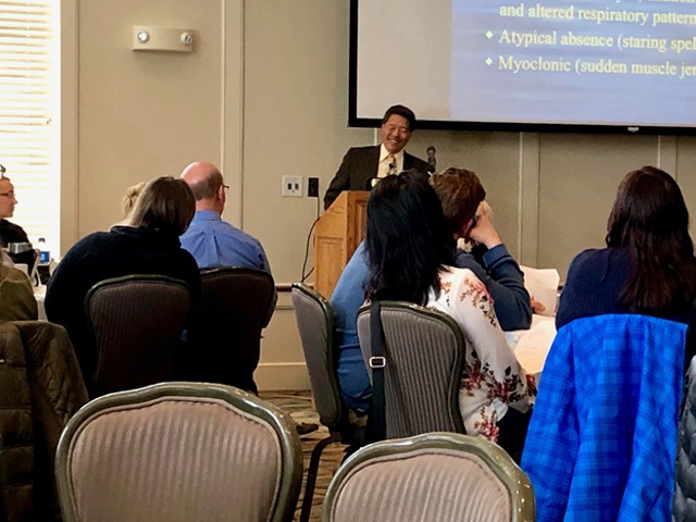 Dentist giving presentation for other dentists