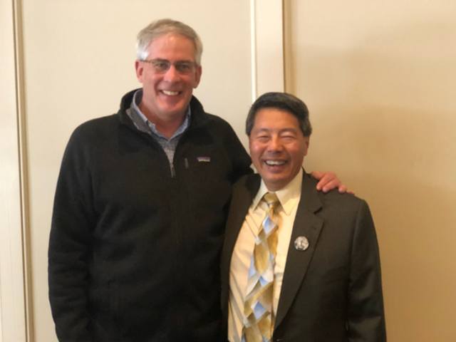 Dentist meeting with presenter from dental conference