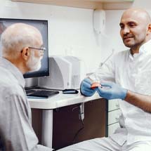 Denture dentist in Montgomery explaining treatment to patient
