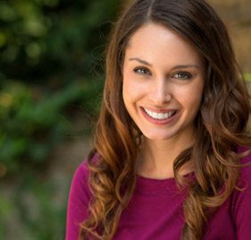 A woman smiling after dental bonding