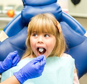 Child receiving dental exam from family dentist