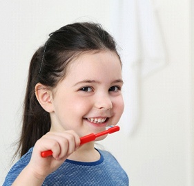 Young girl brushing her teeth