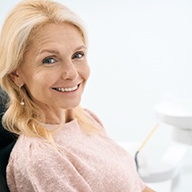 woman smiling after dental implant salvage treatment in Montgomery