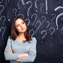 confused woman standing with her arms crossed 