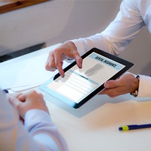 Dentist showing patient dental insurance forms on computer