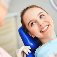 Woman smiling during dental checkup and teeth cleaning visit