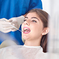 Woman receiving oral cancer screening
