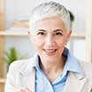 Elderly lady in blue button up smiling
