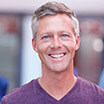 Man in v-neck smiling