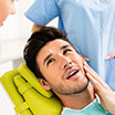 Man in pain lying on dental chair