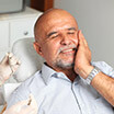 Man in pain clutching head