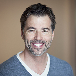 Man smiling after tooth replacement with dental implants
