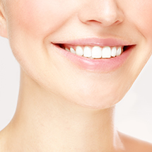 Patient sharing healthy smile after equilibration and occlusal adjustment