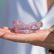 Person holding occlusal splint