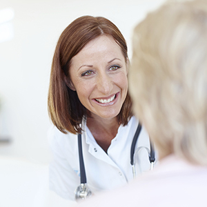 Dentist discussing options for periodontal therapy with patient
