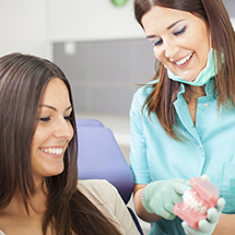 Dentist describing root canal therapy process to dental patient