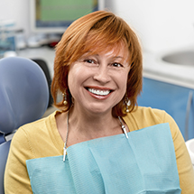 Woman smiling after scaling and root planing treatment