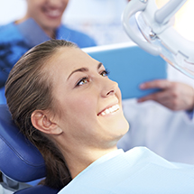 Woman smiling after receiving tooth colored fillings