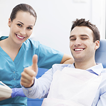 Pleased man giving thumbs up after tooth extractions