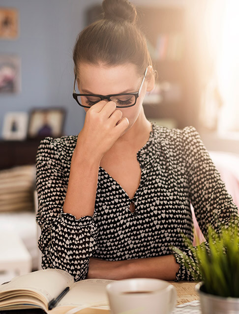 Woman in pain before T M J therapy experiencing a headache