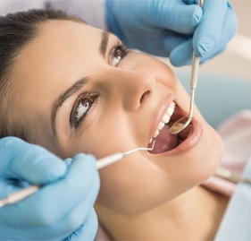 Woman during dental exam after tooth colored filling restoration